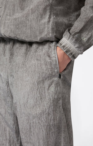 Pantaloni Uomo In Nylon Con Polsini Elastici Effetto Slavato